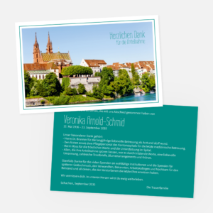Eine Dankeskarte und eine Todesanzeige für Veronika Arnold-Schmid. Die Karte zeigt ein Foto des Basler Münsters und Dächer an einem Fluss, mit dem Text "Herzlichen Dank für die Anteilnahme" in blauer Schrift.